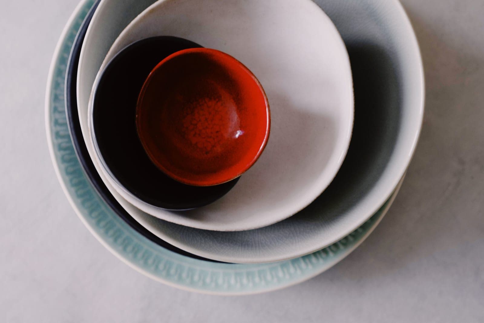 Plain ceramic bowls stacked on a kitchen counter