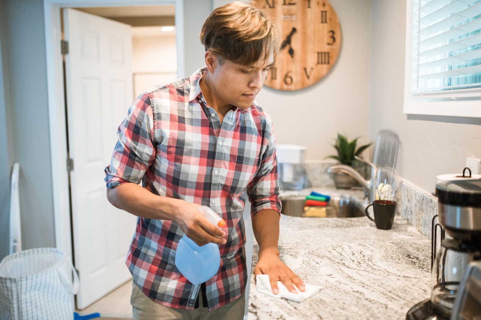 A cloth wiping down a clean kitchen counter