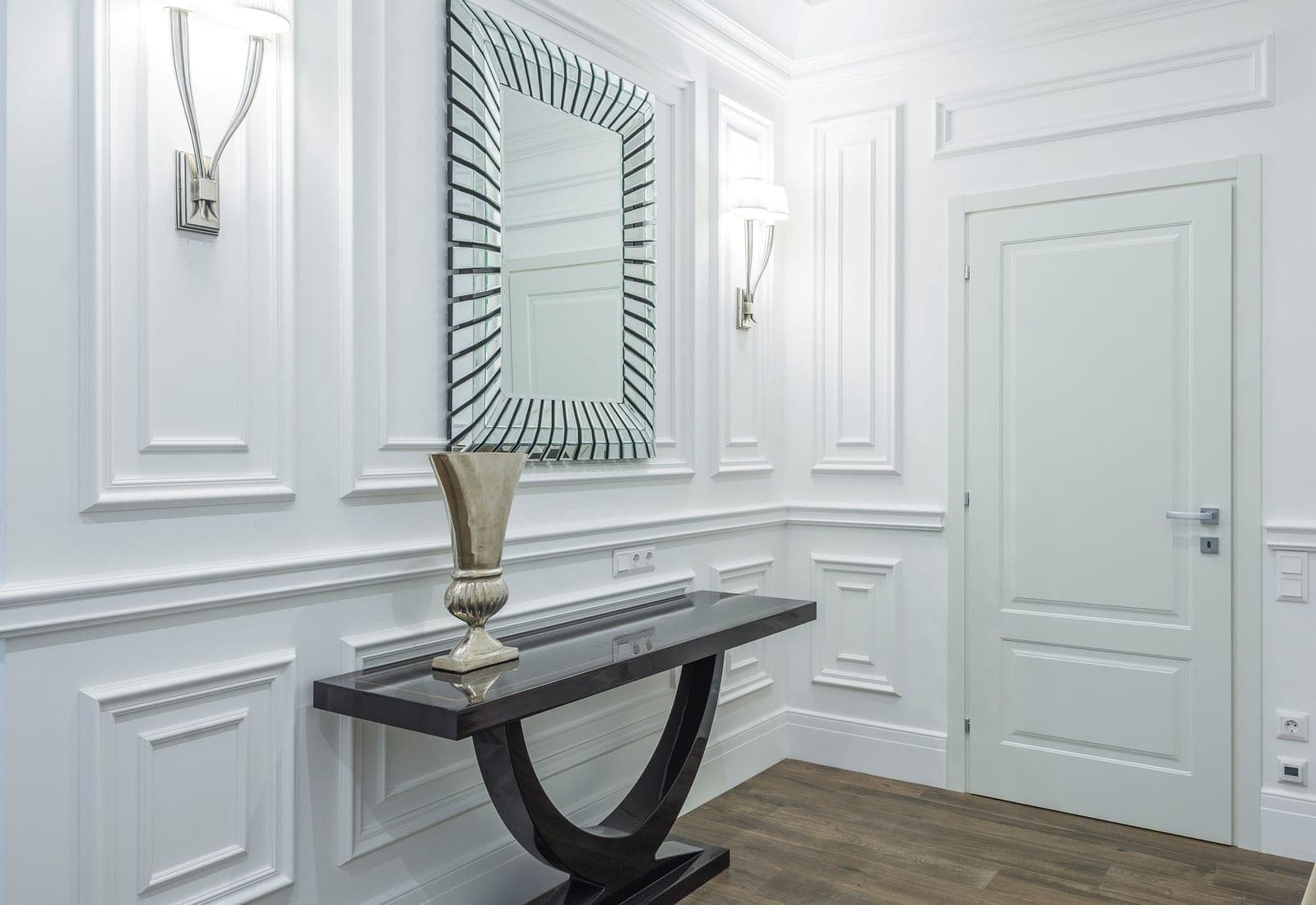 A minimal hallway with a console table against a plain wall