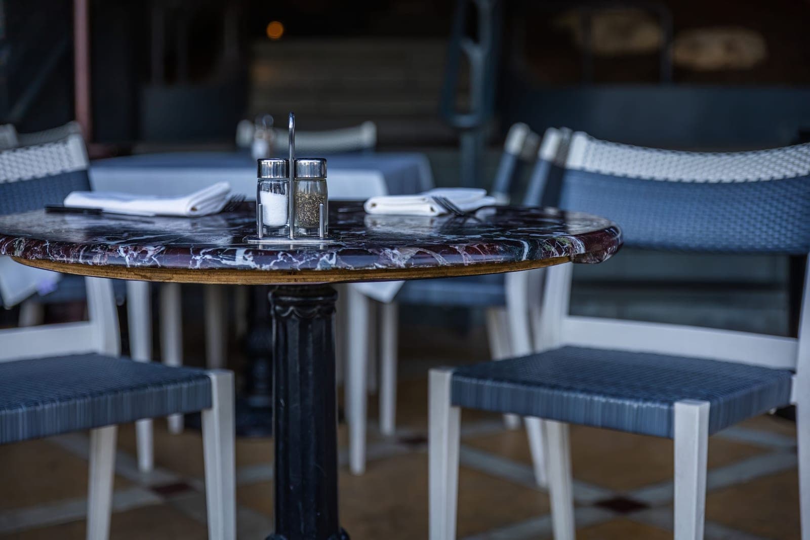 A marble tabletop with a few small objects arranged on it